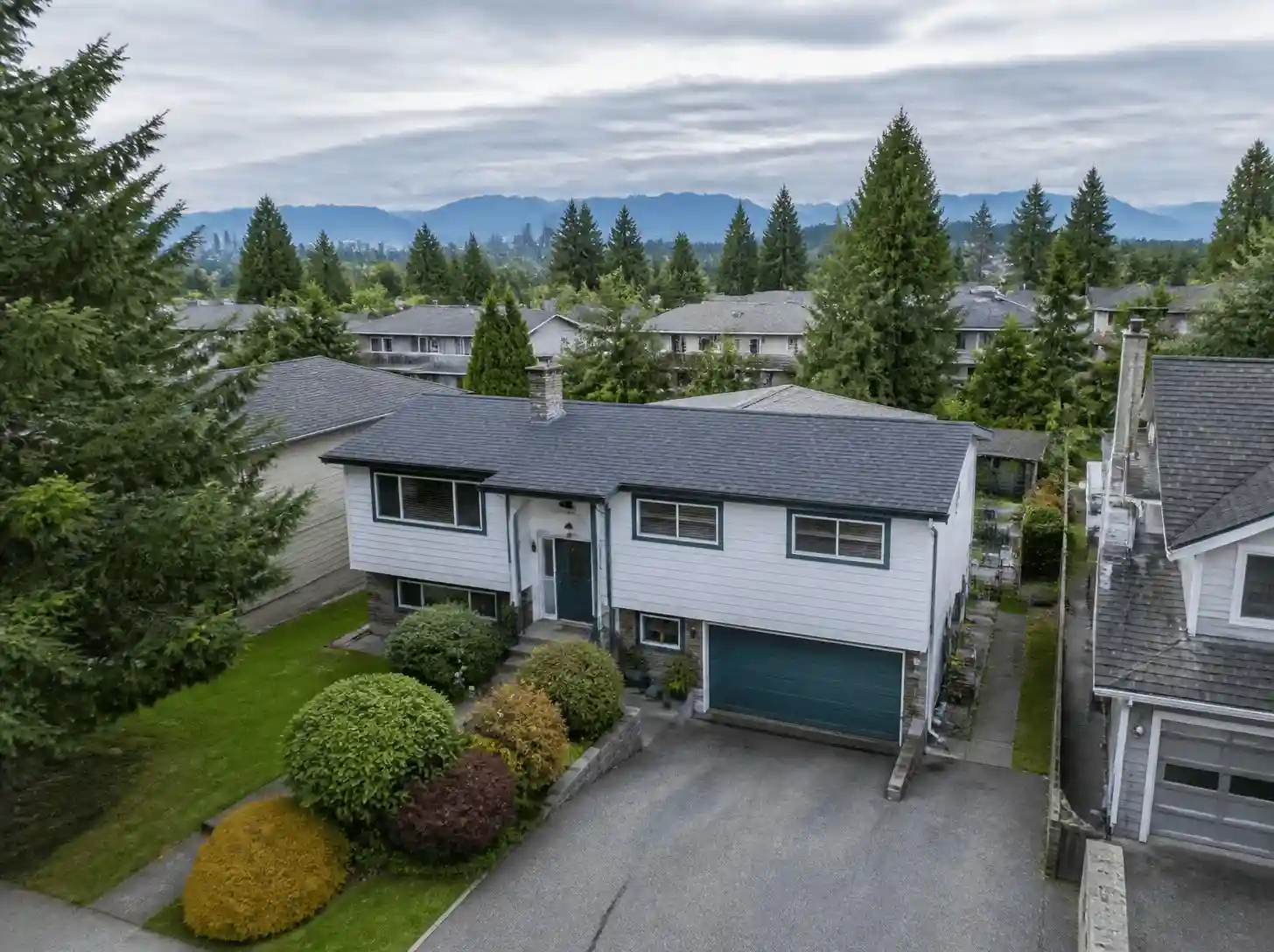 Aerial suburban home with mountain views