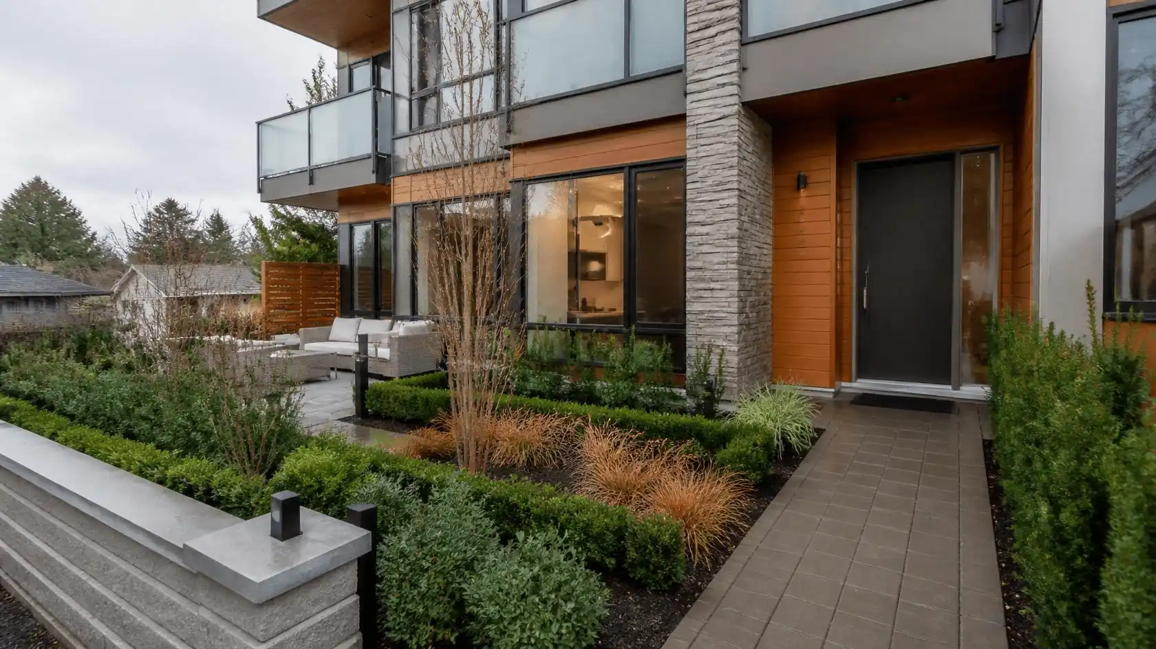 Modern ground level unit with landscaped entrance and patio