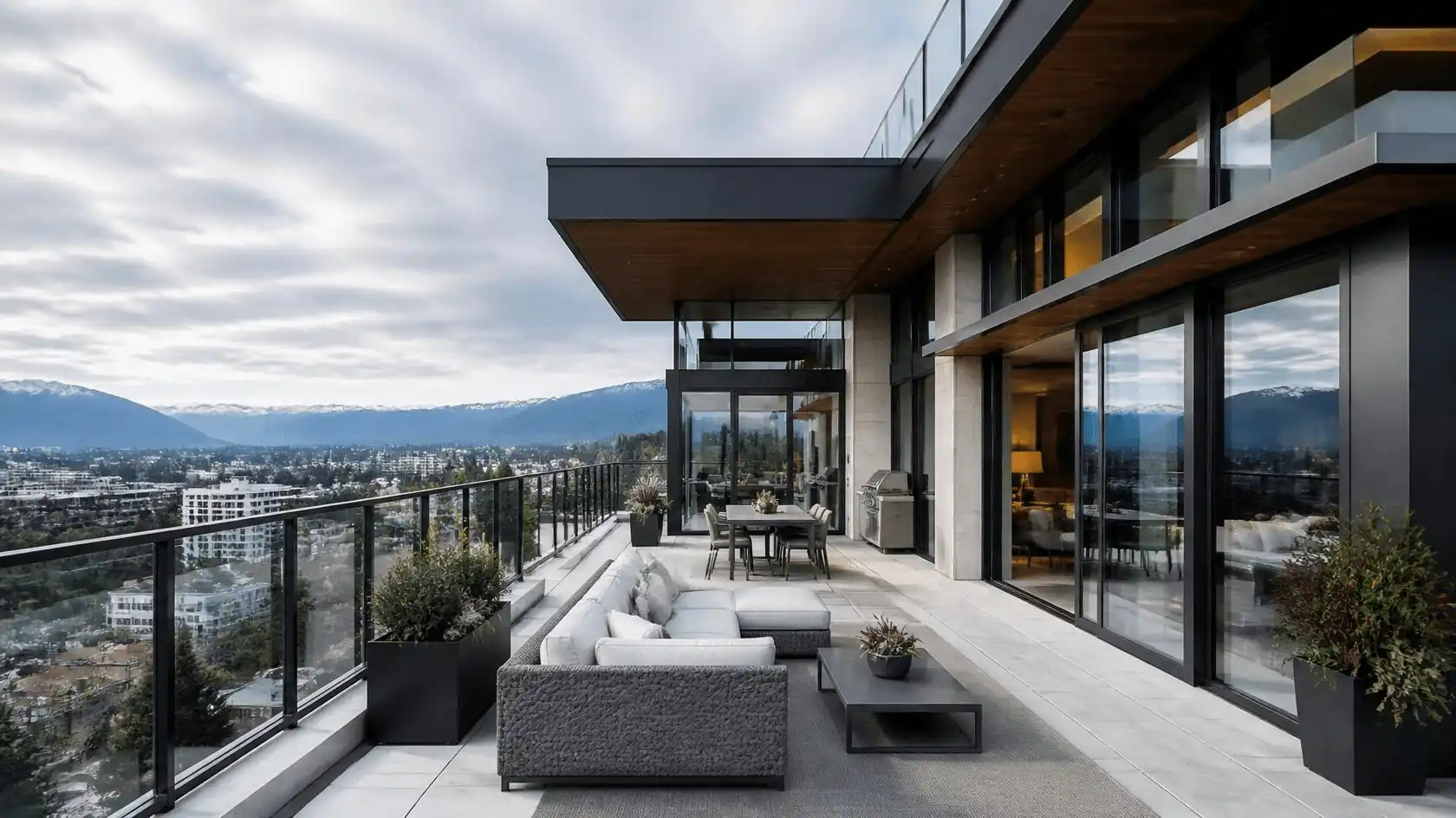 Luxury penthouse terrace with mountain views and glass railing