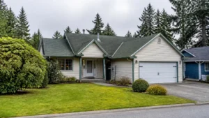 White suburban home with mountain backdrop