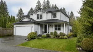 White two-story home with trees