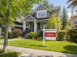 Sold home with a real estate sign in Burnaby representing a successful home sale